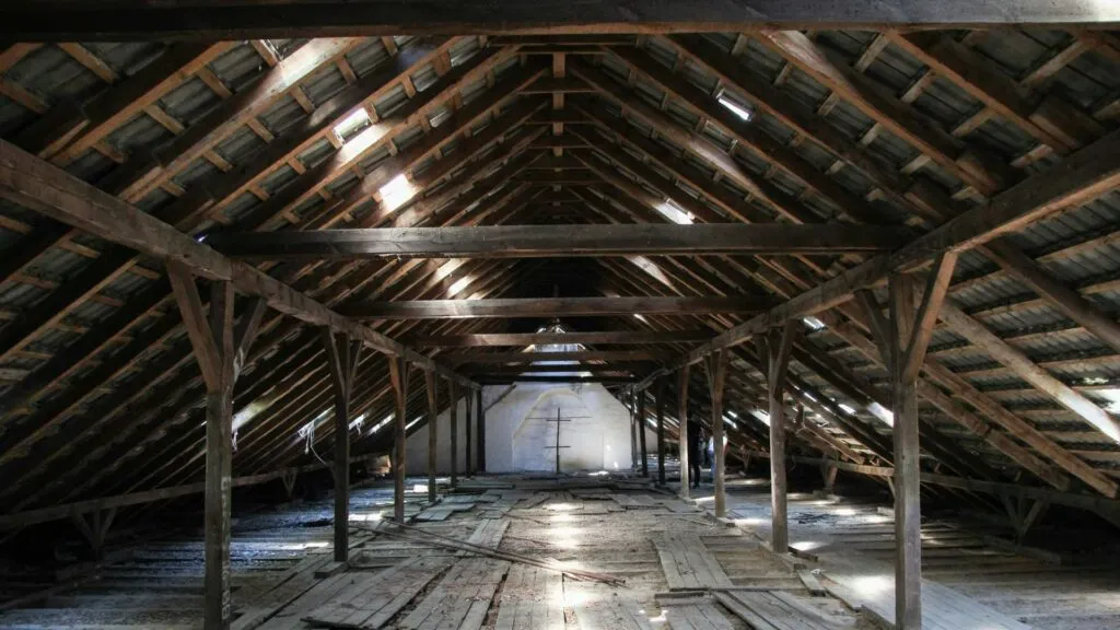 Wooden attic with open gaps before spray foam insulation