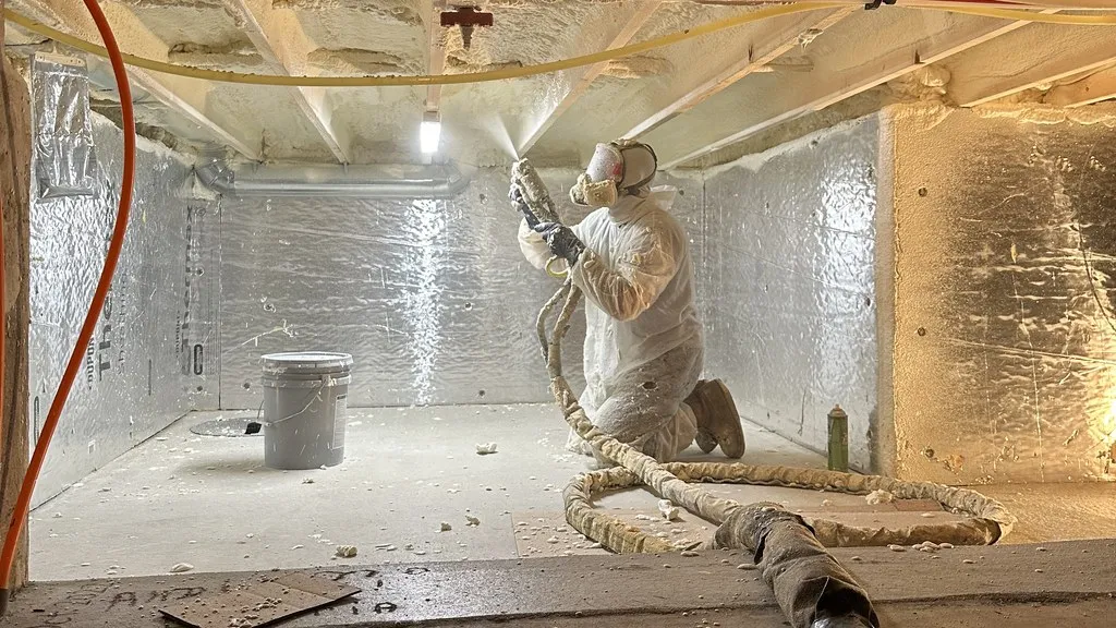 Eco Foam Hawaii installer applying spray foam insulation under a raised home